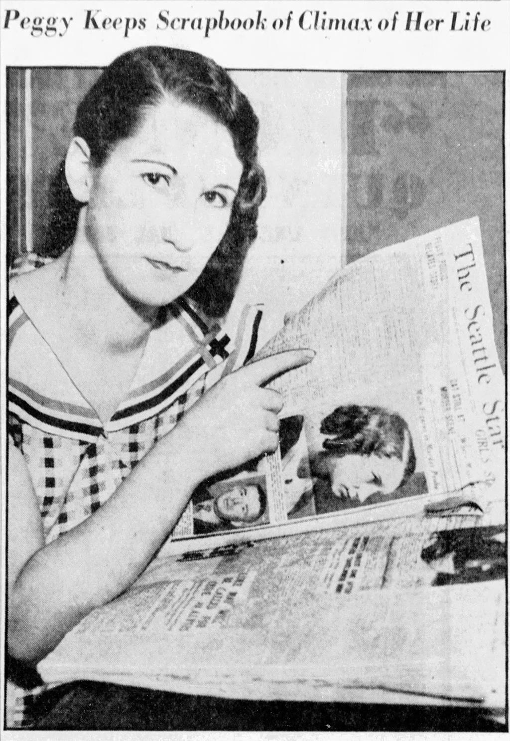 Woman looking into the camera while holding a newspaper with a photo of herself