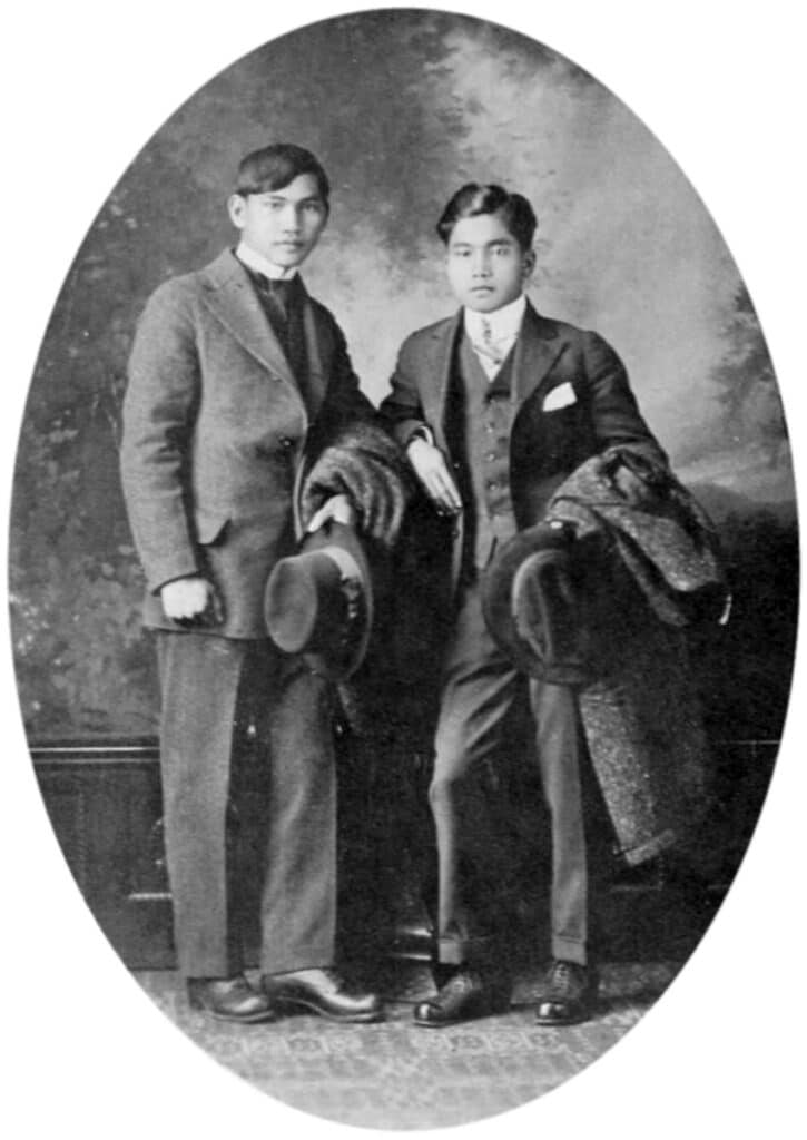 Two young men posing in suits