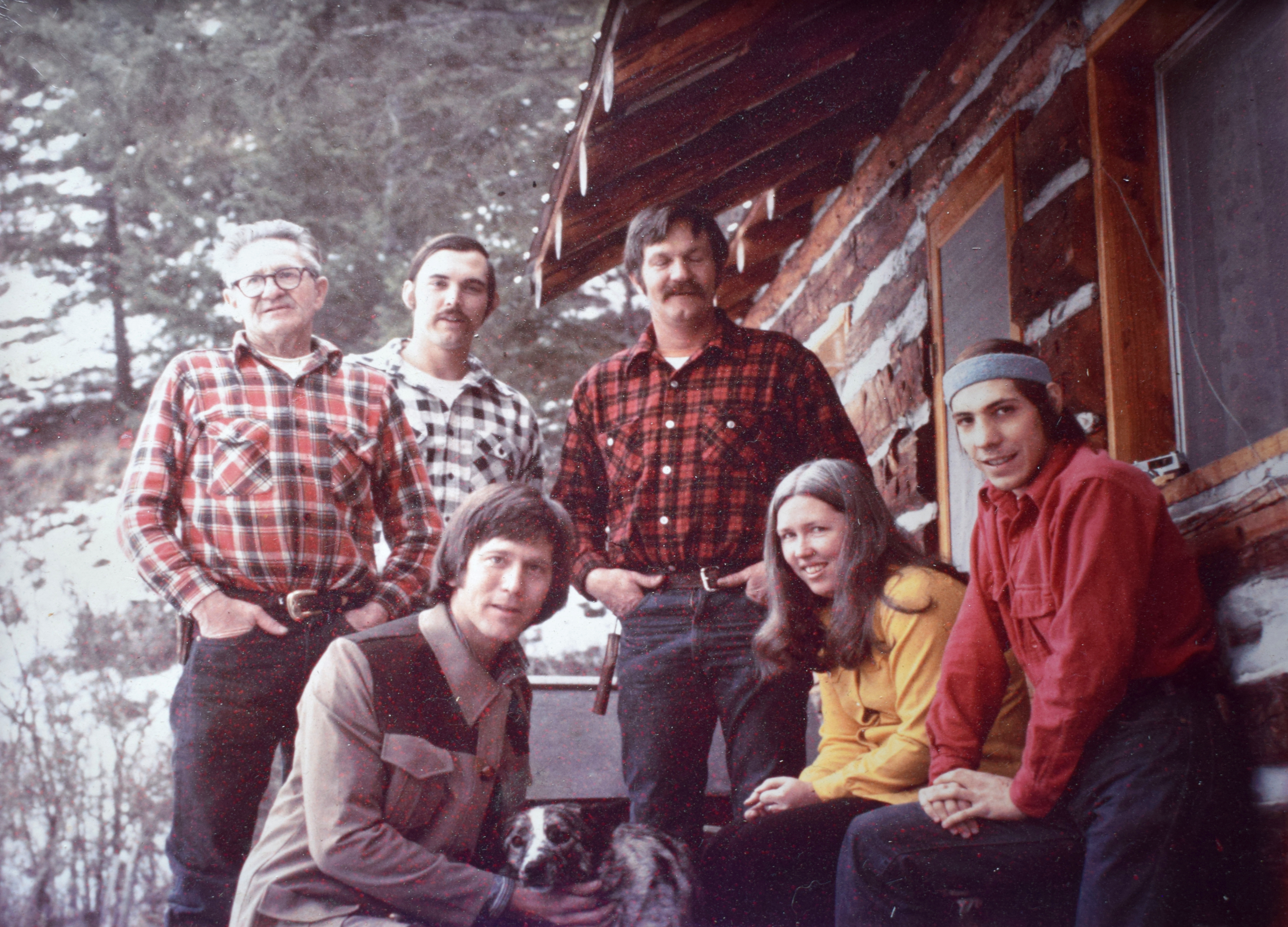 Group standing outside of a cabin